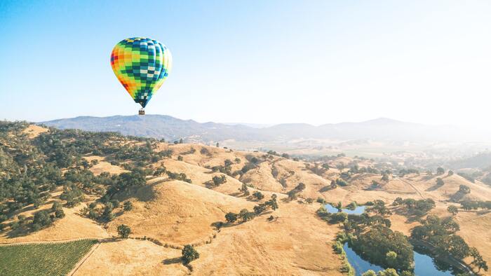 Napa County Rolling Hills with colourful Hot Air Balloon travelling above
