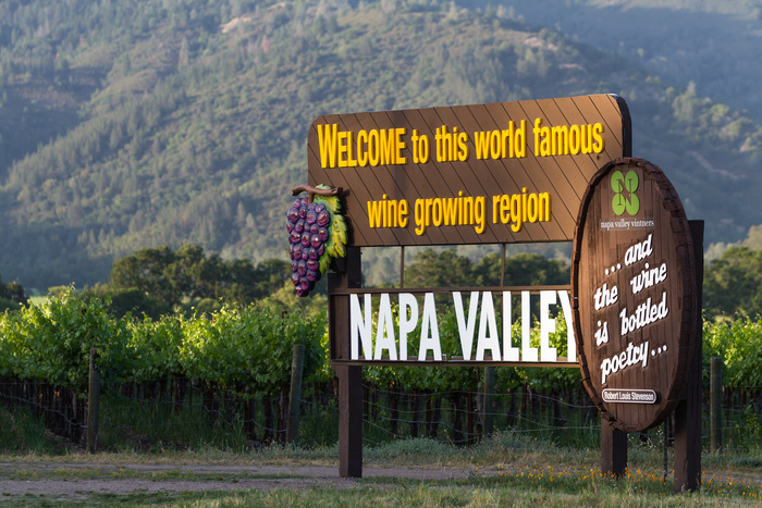 A welcome sign to Napa County, it reads "Welcome to this world famous wine growing region, and the wine is bottled poetry"