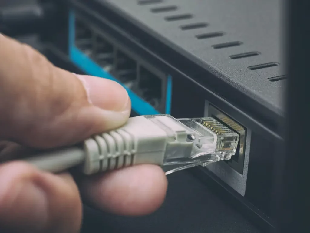 Ethernet Cable being plugged into the appropriate port on a router.