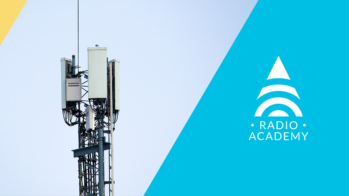Cellular Tower amidst the Tait Radio Academy Logo
