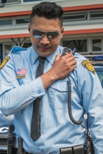 US Policeman using TAIT AXIOM Wearable connected to a Tait Portable Radio